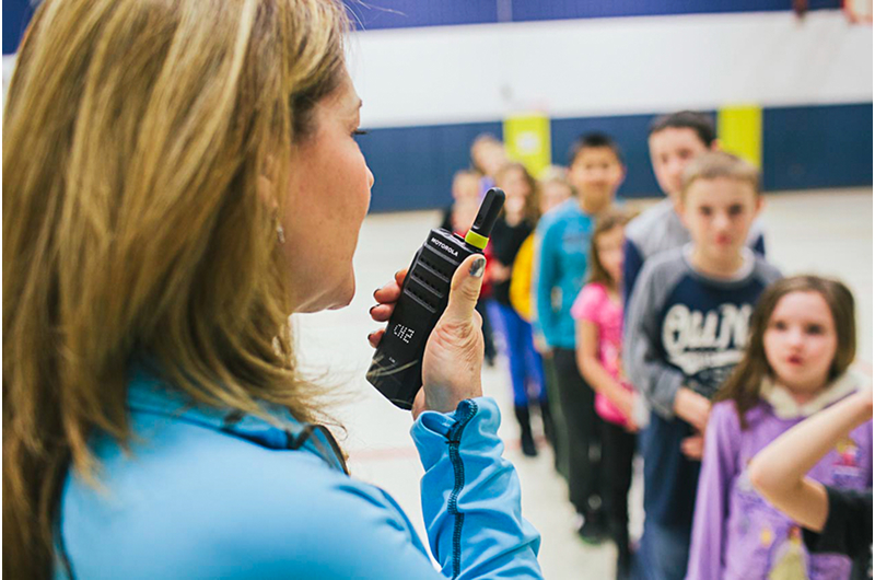 Event staff using radio communication for crowd and operations coordination